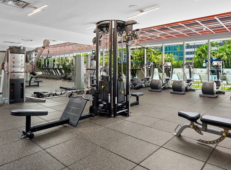 A gym with a variety of equipment including a leg press machine.